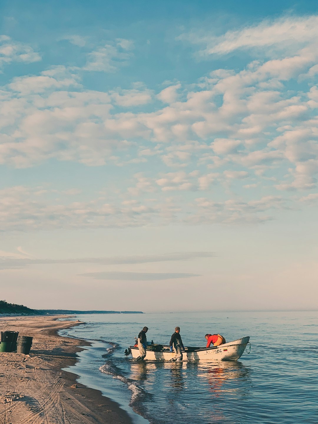 Chilean fishermen unloading wooden boats on the coast of Chiloe