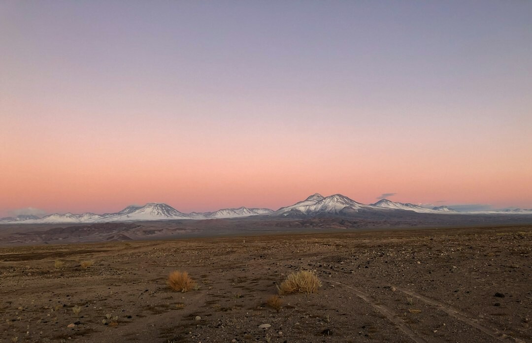 Vast salt flat and mountains in the Atacama desert at sunset