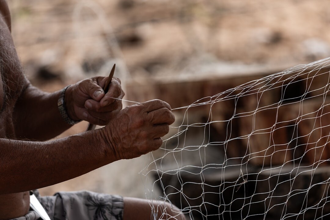 fishermen repairing nets